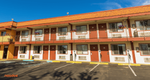 Sustainable hospitality motel chain with EV charging stations in the parking lot